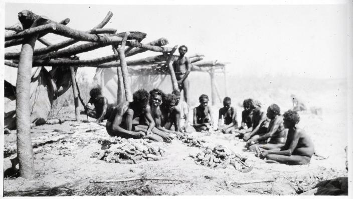 Image of a group of people sitting on the ground